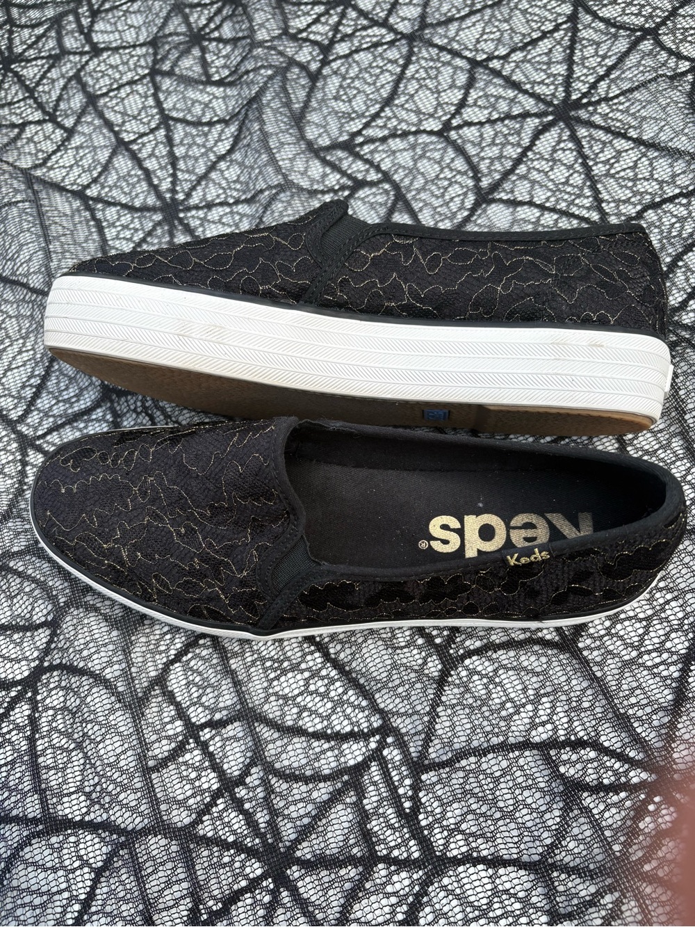 Keds Women’s Black Slip-On Platform Sneakers with Gold Accent Stitching